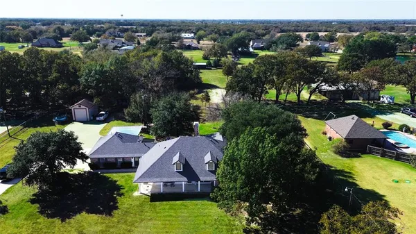 an aerial view of house with yard swimming pool and mountains