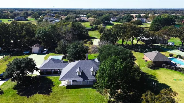 an aerial view of house with yard swimming pool and mountains