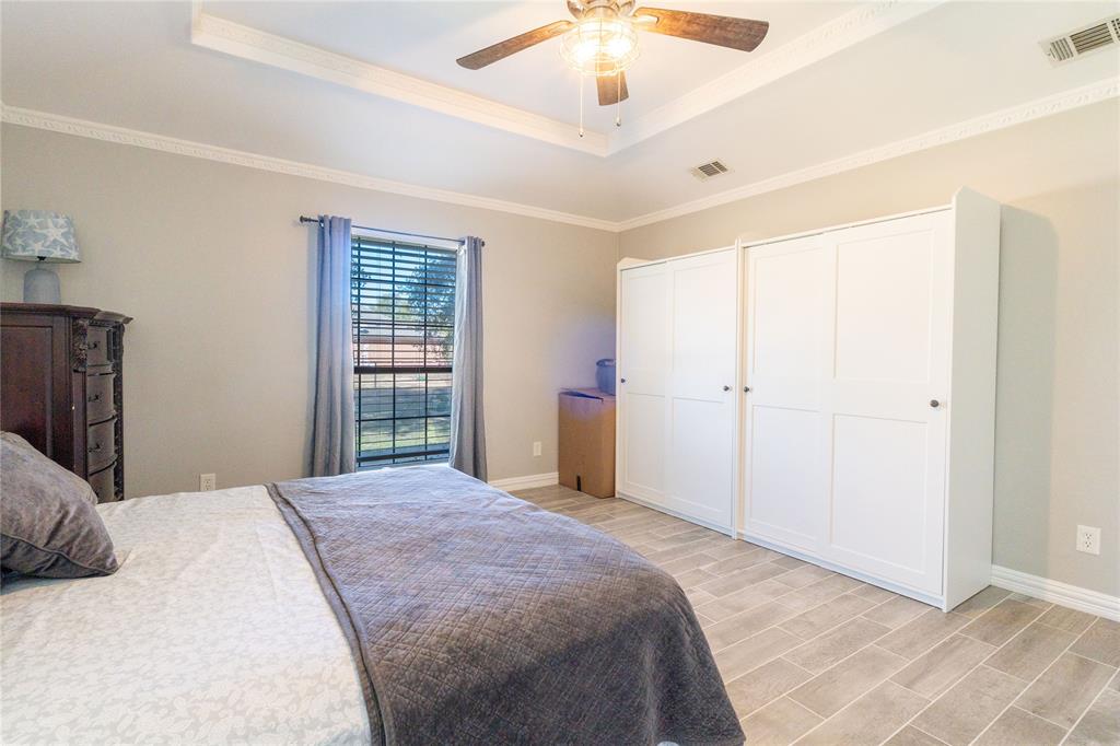 1246 Meadow Way Terrell, TX 75160 - Photo 22 of 39 a bedroom with a large bed and a chandelier