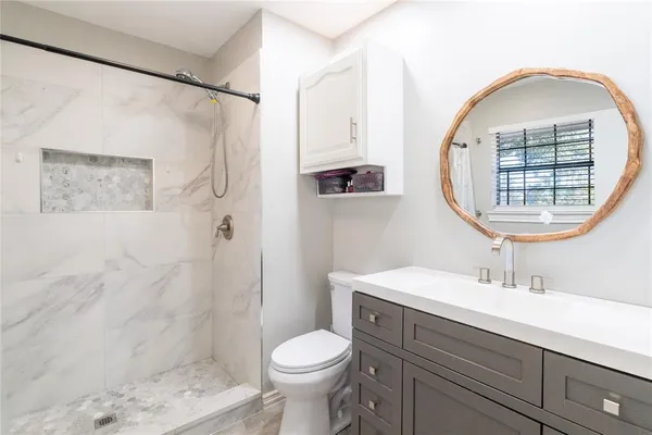 a bathroom with a tub shower and sink