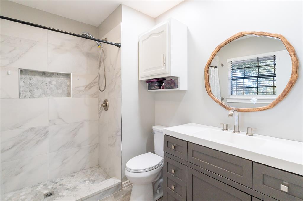 1246 Meadow Way Terrell, TX 75160 - Photo 23 of 39 a bathroom with a sink toilet and shower