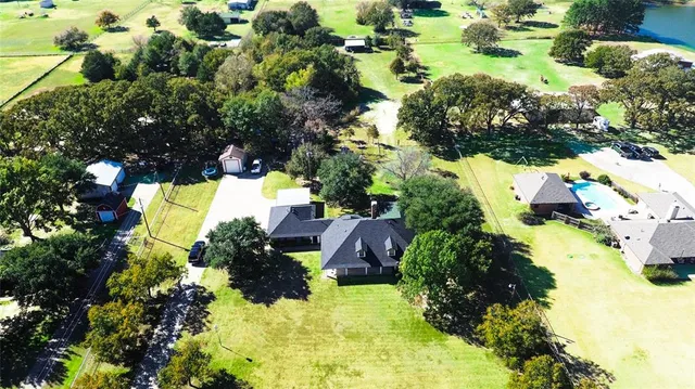 an aerial view of a house with a yard