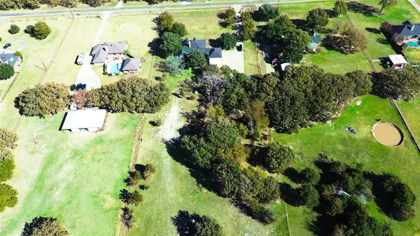 a kitchen with a stove a sink dishwasher and white cabinets with wooden floor