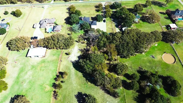 a kitchen with a stove a sink dishwasher and white cabinets with wooden floor