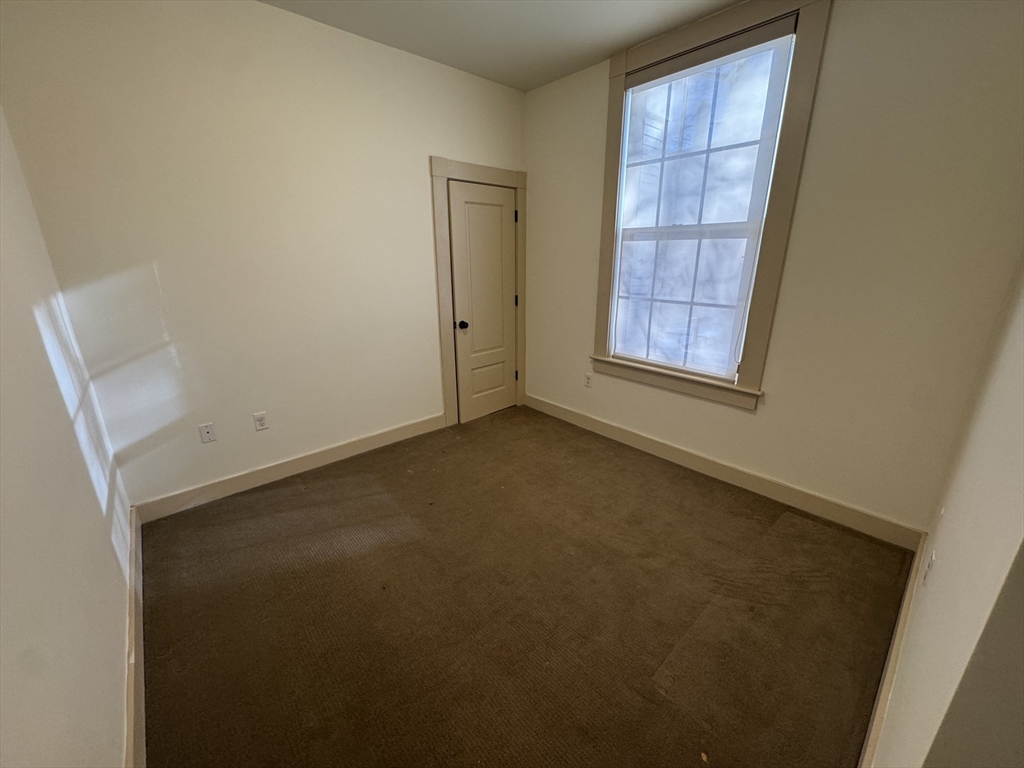 10 Linwood Street, Unit 3 Boston, MA 02119 - Photo 13 of 16 an empty room with windows