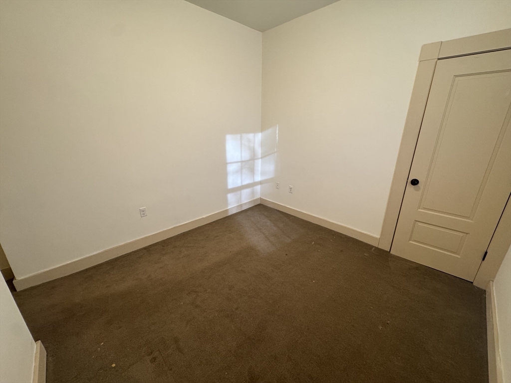 10 Linwood Street, Unit 3 Boston, MA 02119 - Photo 14 of 16 an empty room with a door