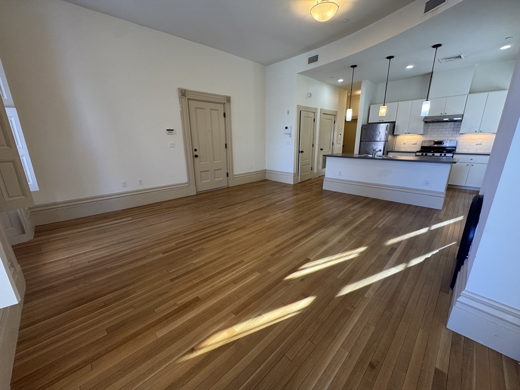 10 Linwood Street, Unit 3 Boston, MA 02119 - Photo 2 of 16 a view of kitchen with cabinets and wooden floor