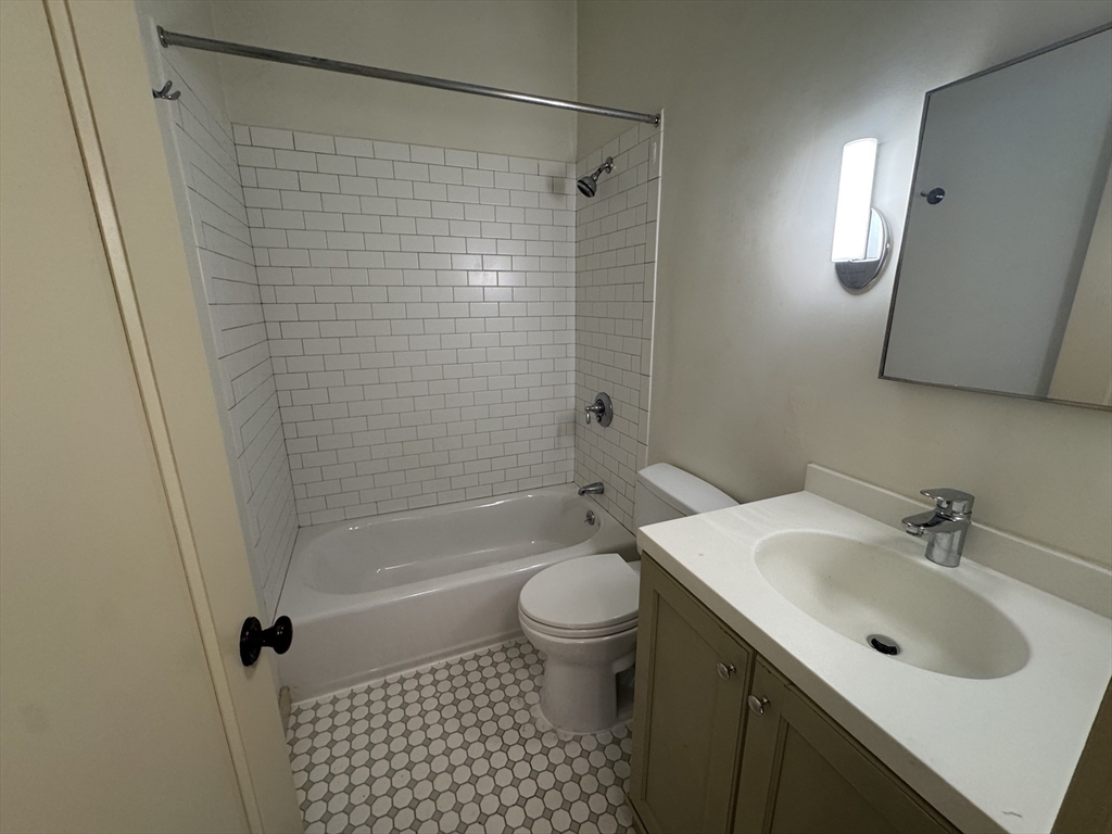 10 Linwood Street, Unit 3 Boston, MA 02119 - Photo 8 of 16 a bathroom with a sink toilet and shower