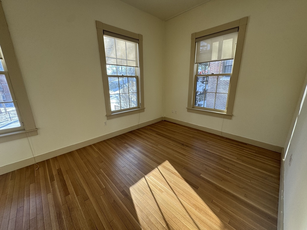 10 Linwood Street, Unit 3 Boston, MA 02119 - Photo 9 of 16 a view of wooden floor in a room next to a window