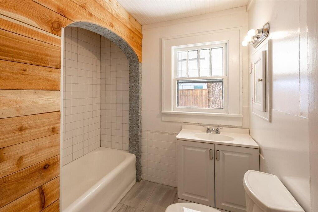 2215 18th Street, Unit FRONT Lubbock, TX 79401 - Photo 11 of 19 a bathroom with a sink a toilet and shower