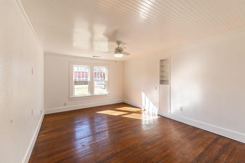 2215 18th Street, Unit FRONT Lubbock, TX 79401 - Photo 17 of 19 an empty room with wooden floor and windows