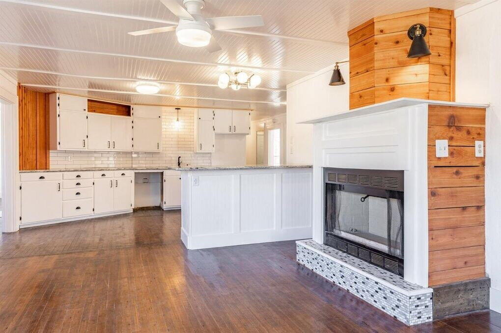 2215 18th Street, Unit FRONT Lubbock, TX 79401 - Photo 2 of 19 a large white kitchen with granite countertop a stove a sink and dishwasher