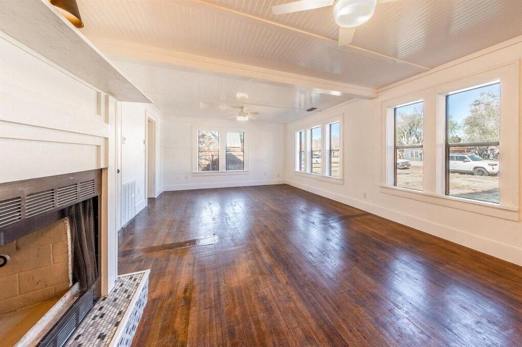 2215 18th Street, Unit FRONT Lubbock, TX 79401 - Photo 4 of 19 a view of an empty room with wooden floor and a window