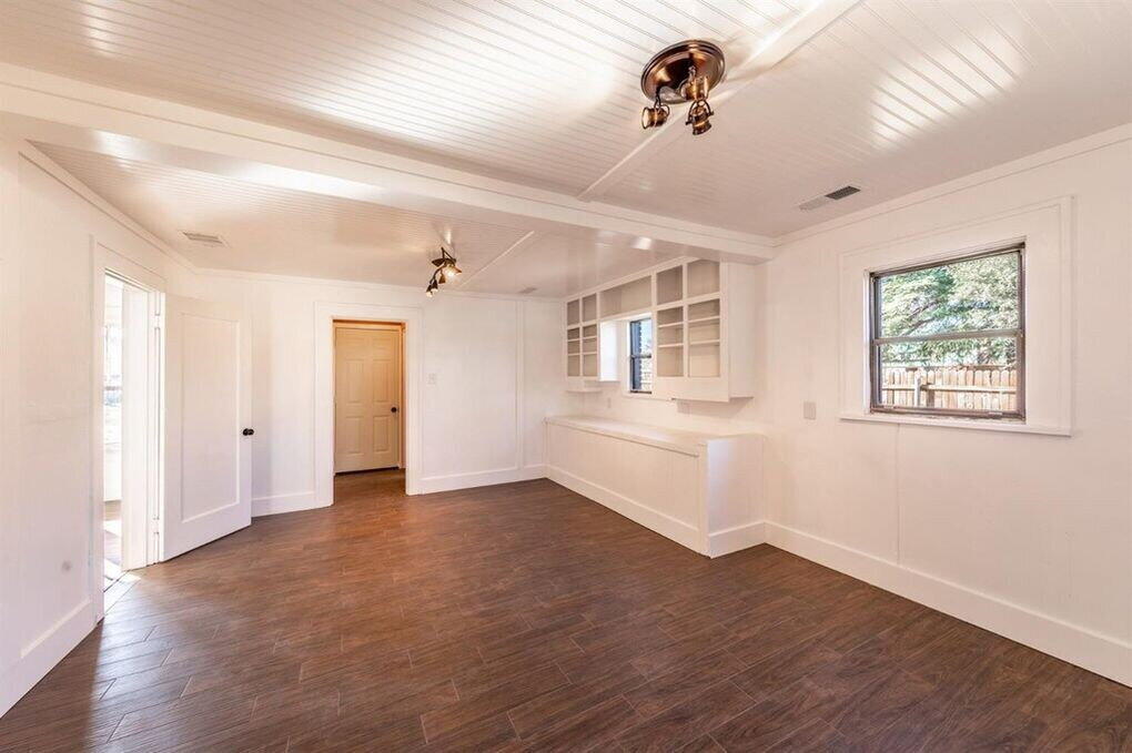 2215 18th Street, Unit FRONT Lubbock, TX 79401 - Photo 6 of 19 a view of an empty room with window and wooden floor