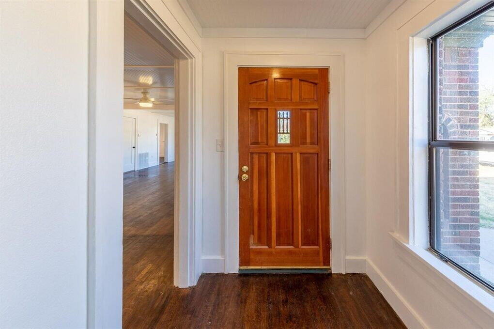 2215 18th Street, Unit FRONT Lubbock, TX 79401 - Photo 8 of 19 an empty room with wooden floor closet and windows