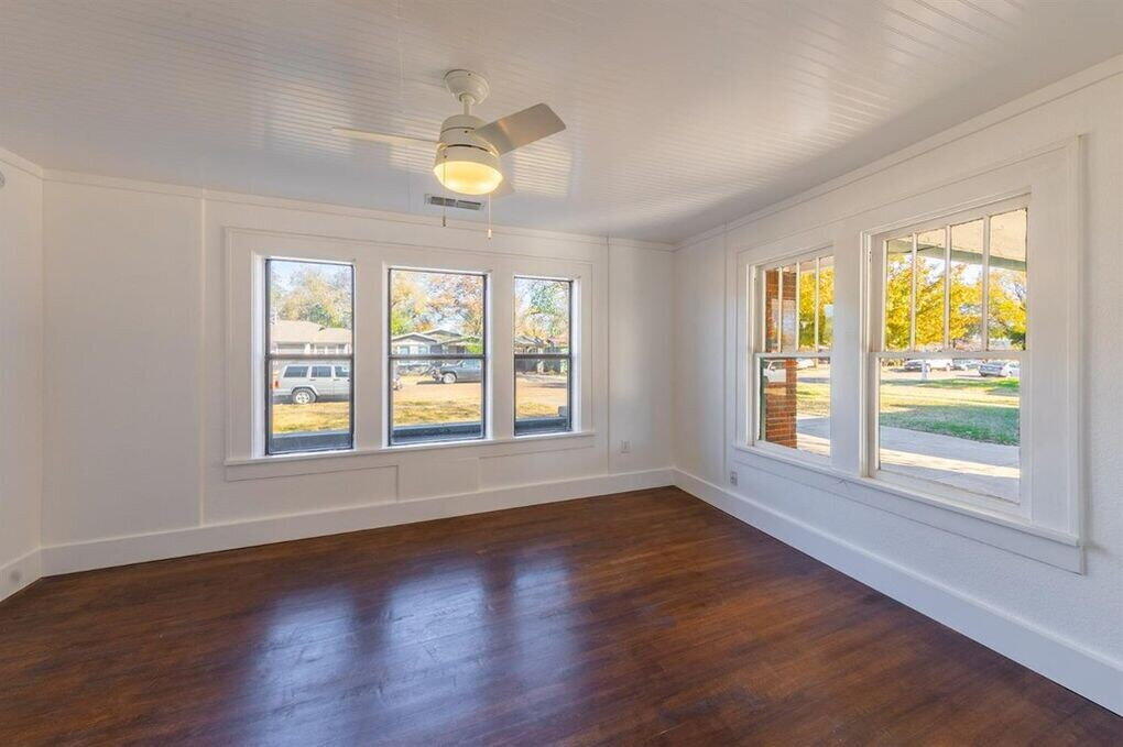 2215 18th Street, Unit FRONT Lubbock, TX 79401 - Photo 9 of 19 a view of an empty room with wooden floor and a window