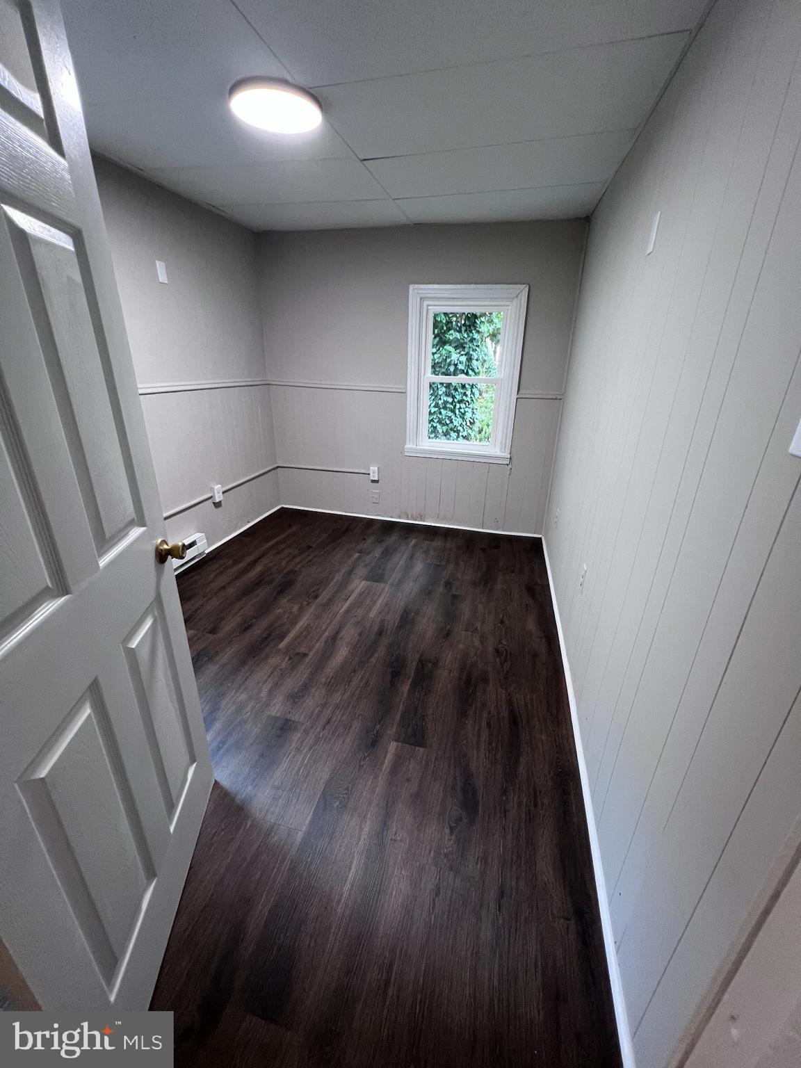 20 Olive Street, Unit C Salem, NJ 08079 - Photo 9 of 11 an empty room with wooden floor and windows