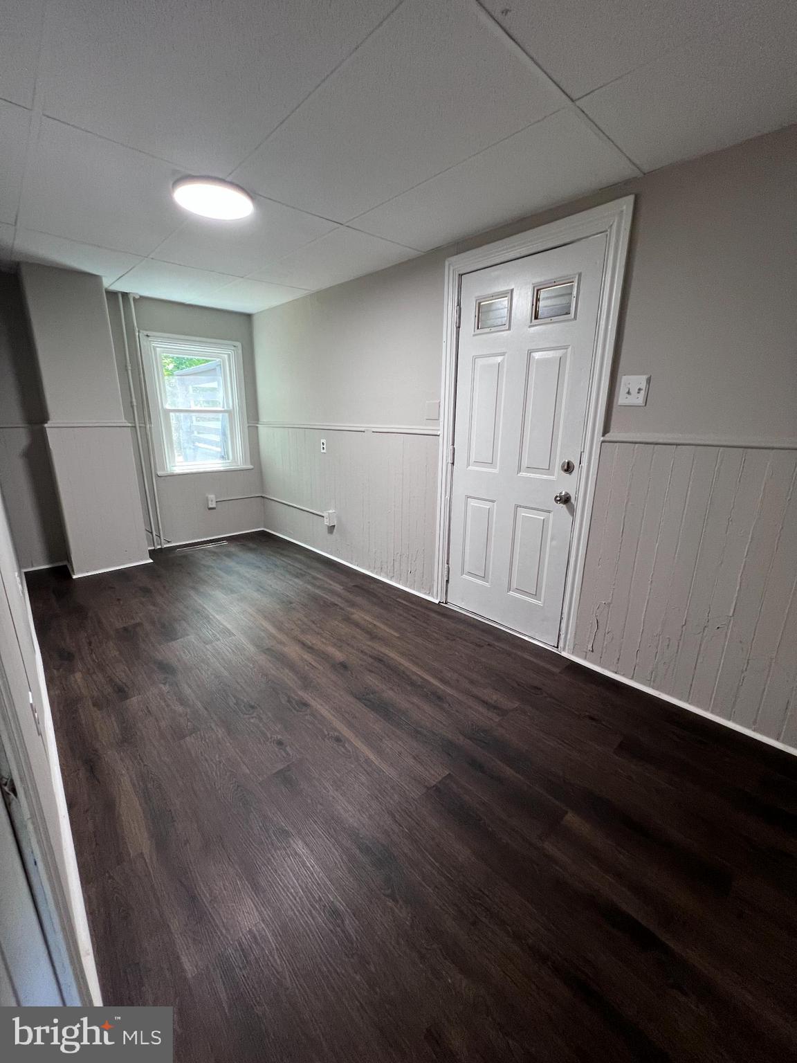 20 Olive Street, Unit C Salem, NJ 08079 - Photo 10 of 11 an empty room with wooden floor and windows