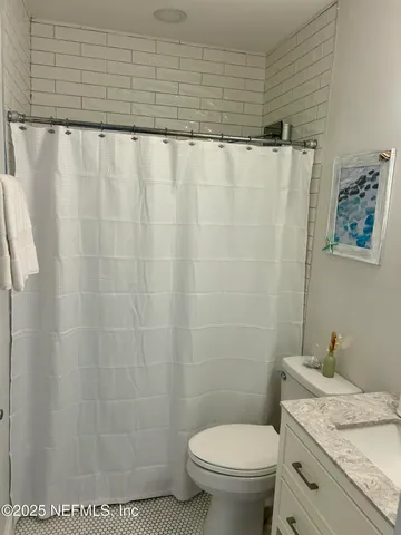 a bathroom with a toilet a sink and a mirror