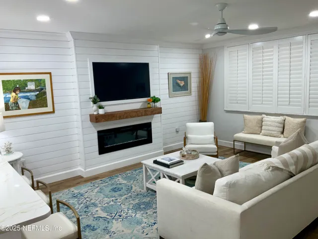 a living room with furniture and a flat screen tv