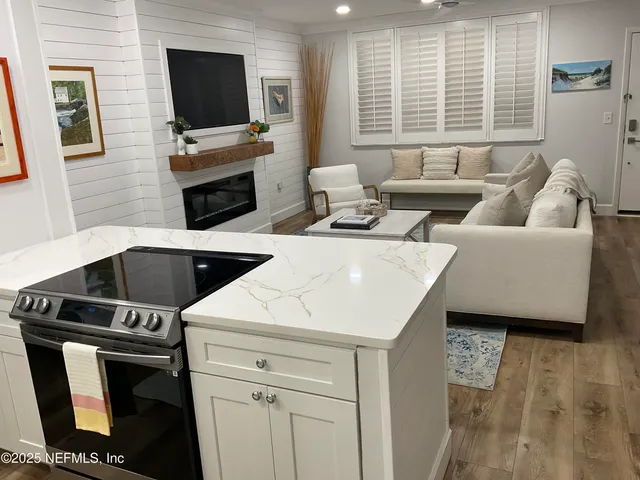 a view of a bedroom with wooden floor