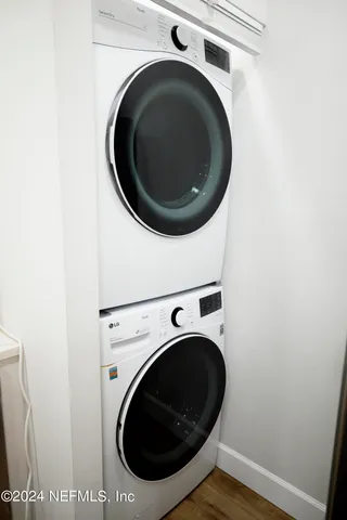 a bathroom with a granite countertop sink and a toilet
