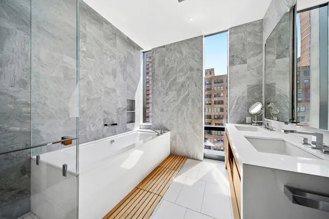 a spacious bathroom with sink shower and bathtub