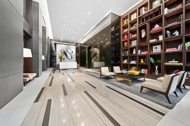 a view of a lobby with furniture and book shelf