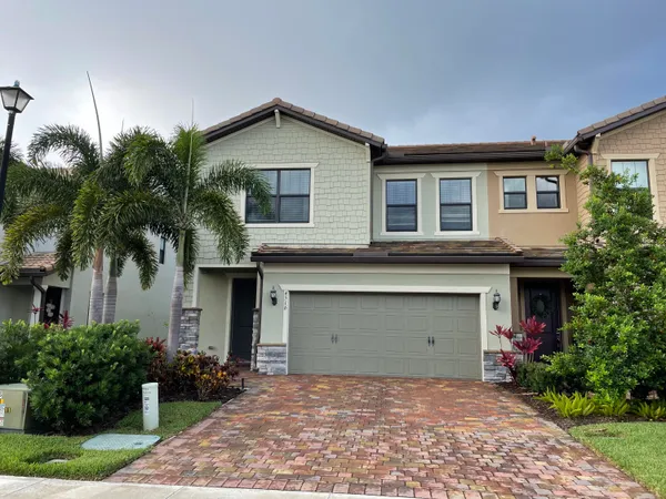 a front view of a house with a garage
