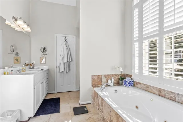 a bath tub sitting in a bathroom next to a window