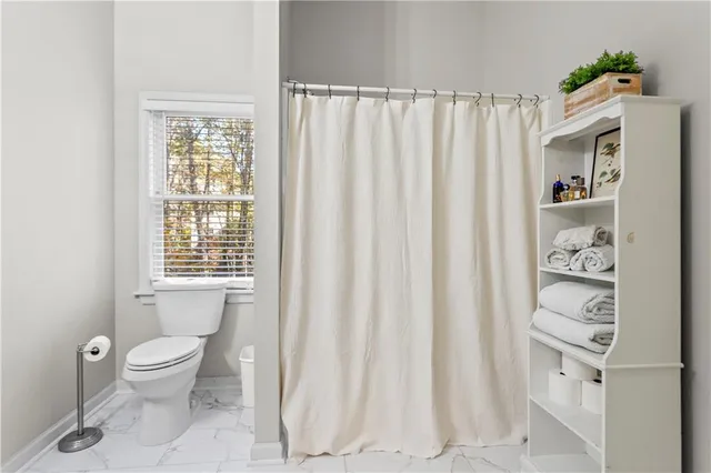 a view of entryway bedroom and hall with wooden floor