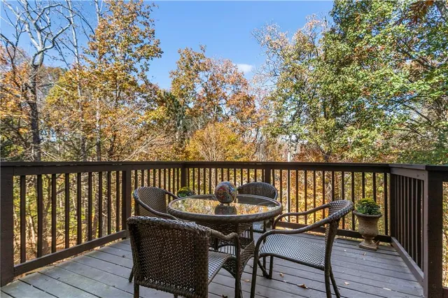 a view of a backyard with chairs and potted plants