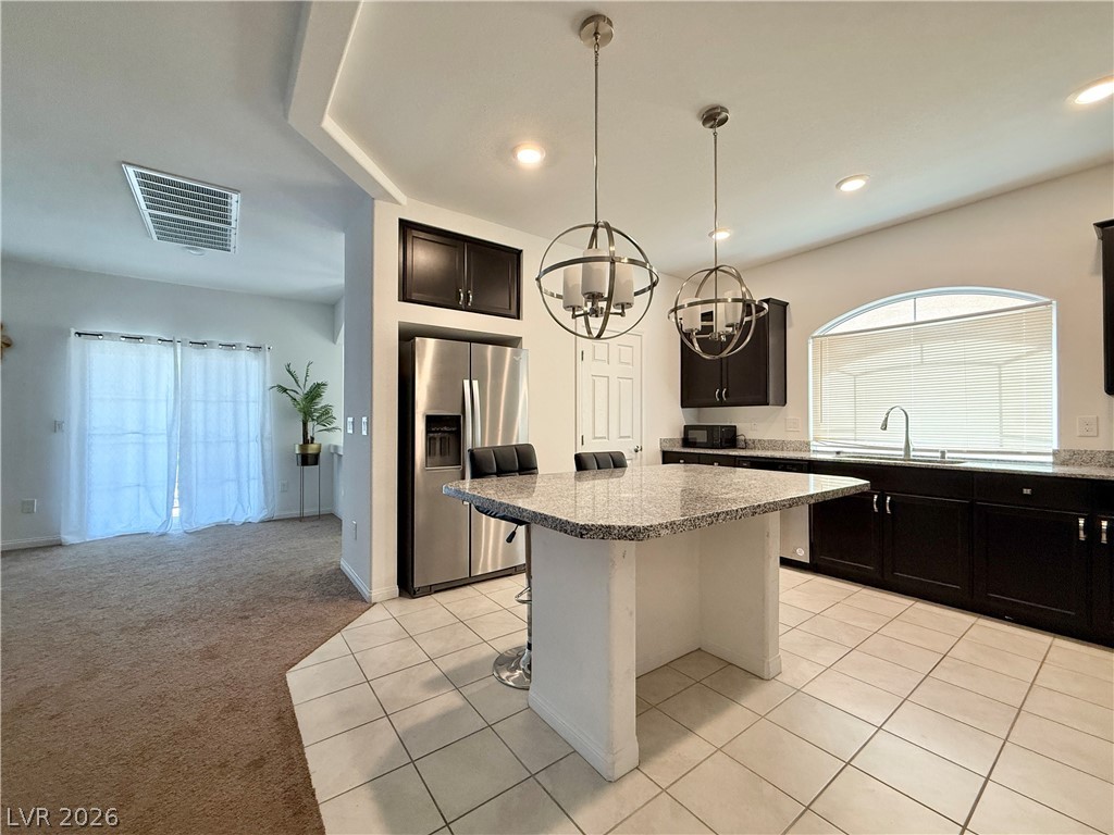 7777 South Westwind Road Las Vegas, NV 89139 - Photo 33 of 46 A well-appointed kitchen showcasing a granite island and contemporary stainless steel appliances.