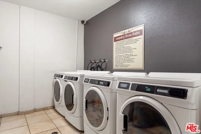 a view of washer and dryer with kitchen in the background