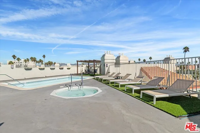a living room with furniture a chandelier and a table