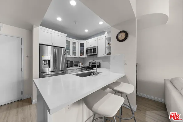 a kitchen with refrigerator cabinets dining table and chairs