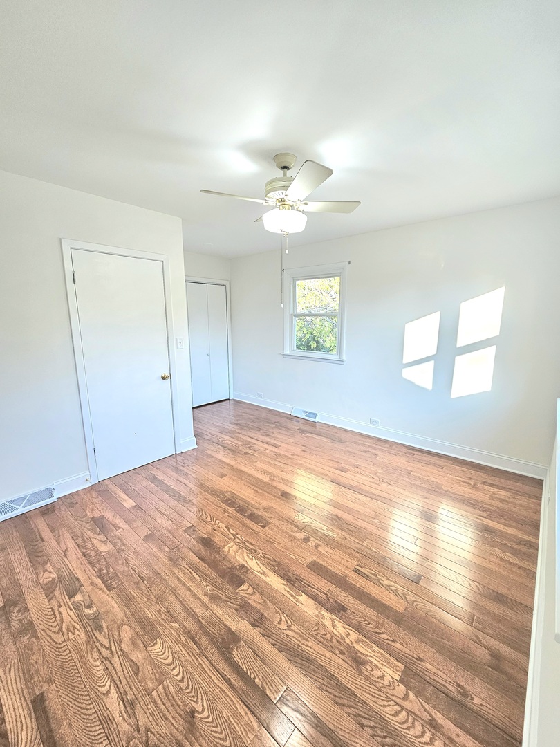 7434 Emerson Street Morton Grove, IL 60053 - Photo 11 of 38 a view of empty room with wooden floor and fan
