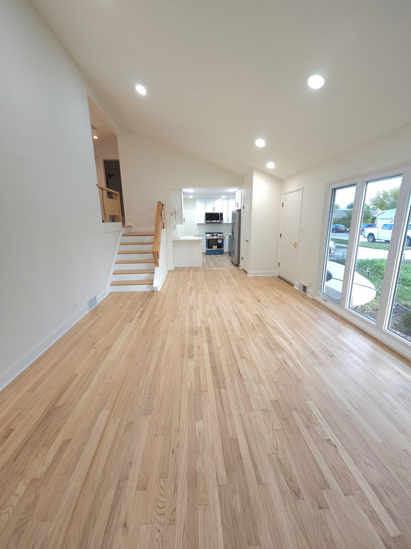 7434 Emerson Street Morton Grove, IL 60053 - Photo 4 of 38 a view of empty room with wooden floor and floor to ceiling window