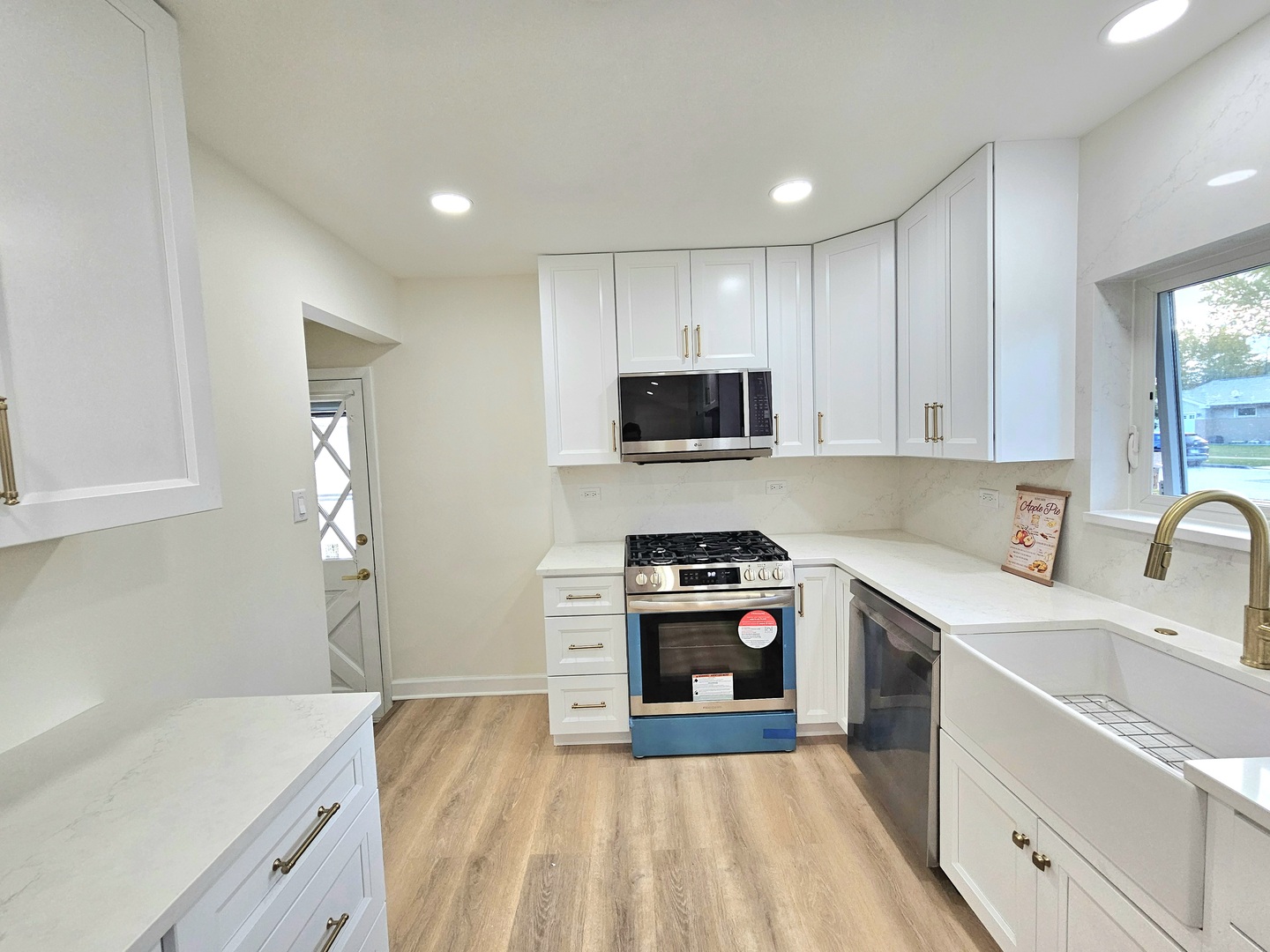 7434 Emerson Street Morton Grove, IL 60053 - Photo 9 of 38 a kitchen with stainless steel appliances a stove sink microwave and cabinets
