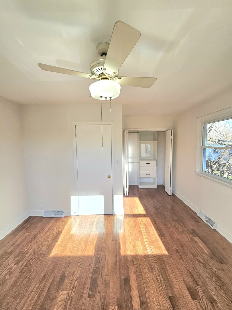 7434 Emerson Street Morton Grove, IL 60053 - Photo 10 of 38 a view of a room with wooden floor and ceiling fan