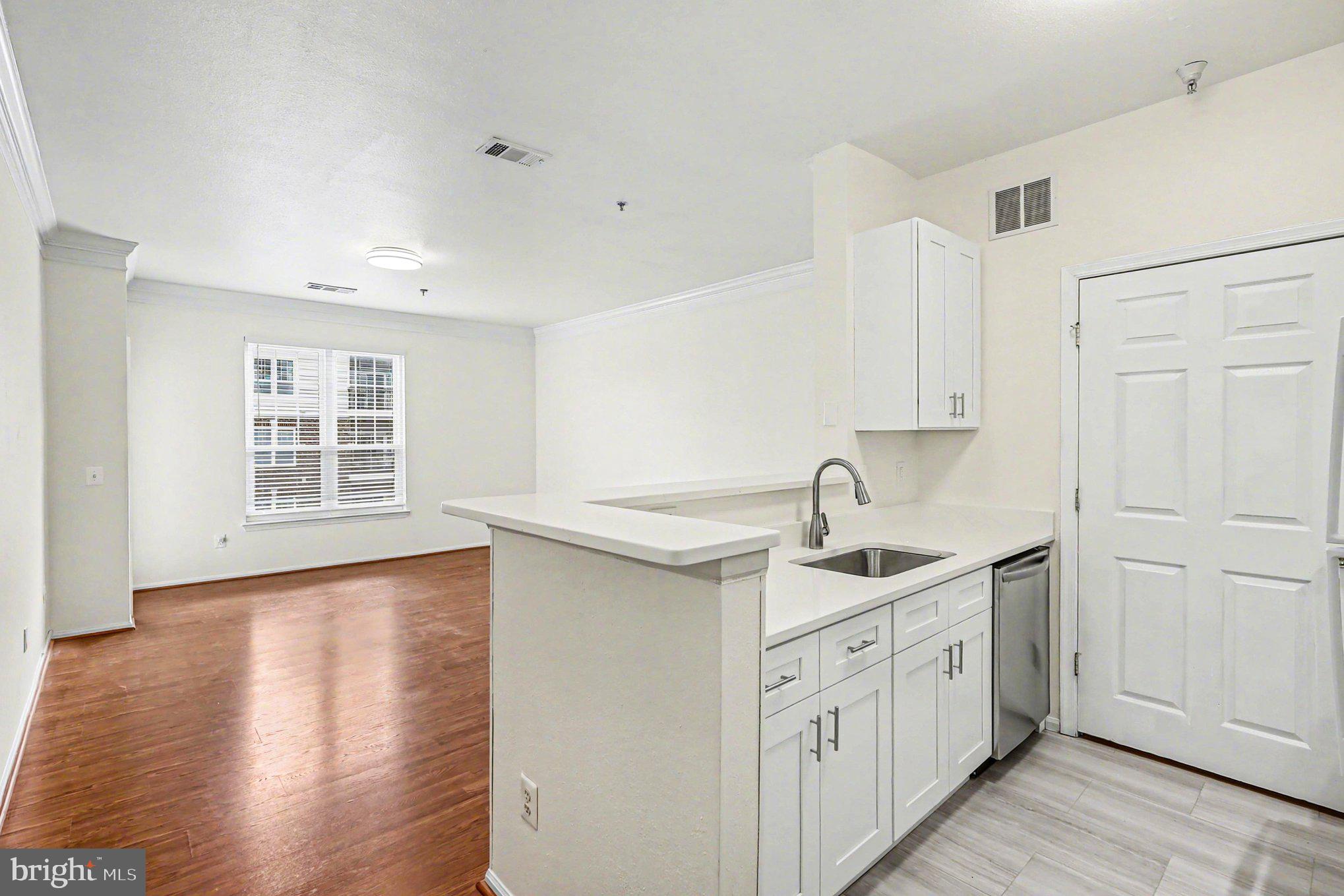 1570 Spring Gate Dr., Unit 7201 McLean, VA 22102 - Photo 1 of 20 Kitchen and living room view