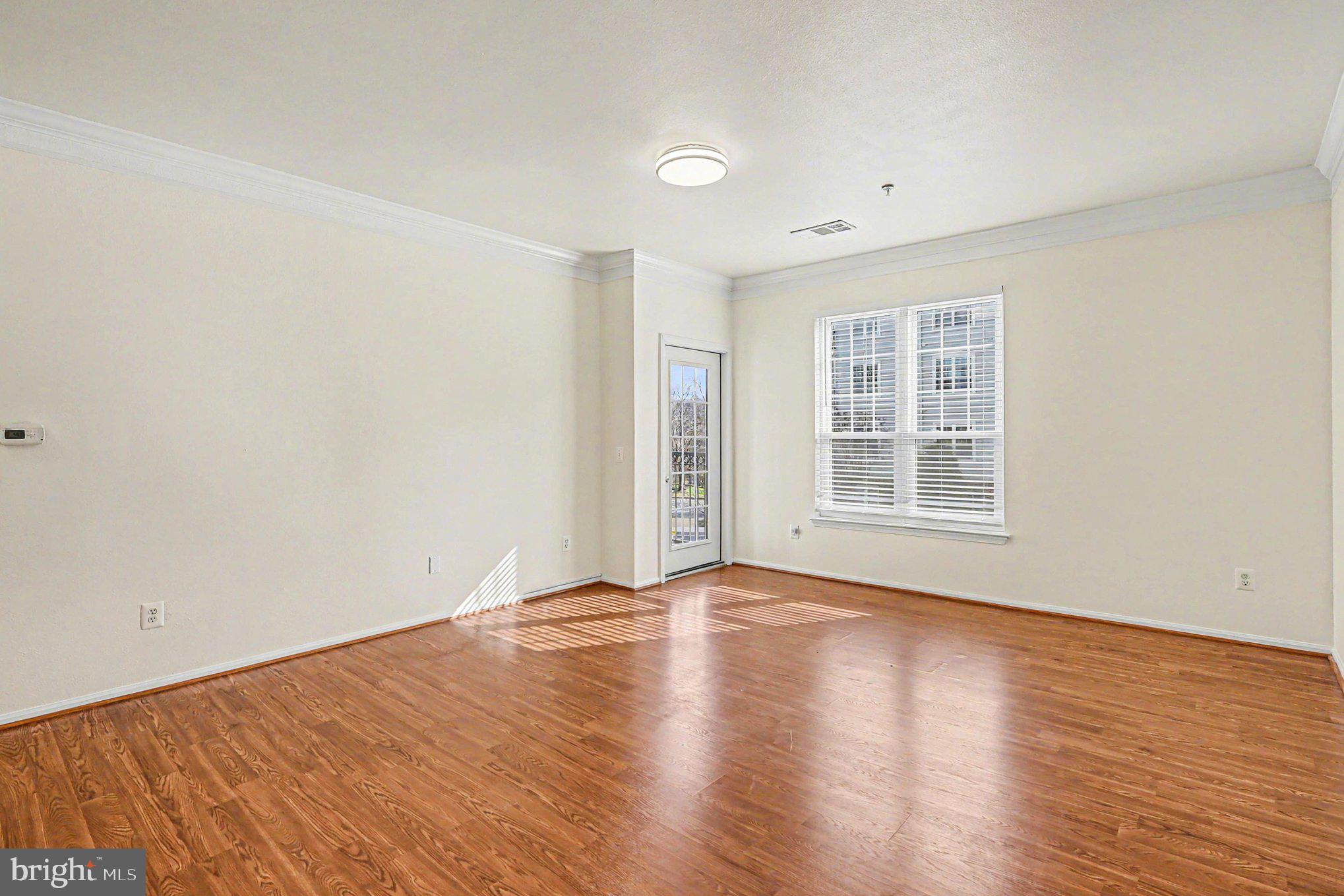 1570 Spring Gate Dr., Unit 7201 McLean, VA 22102 - Photo 11 of 20 Living room and access to the balcony