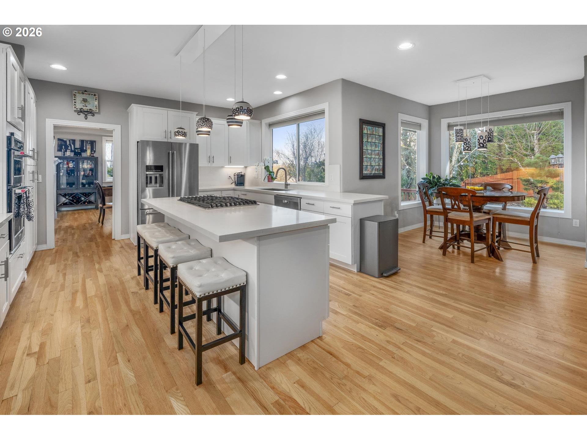 13072 Southwest Morningstar Drive Portland, OR 97223 - Photo 9 of 48 a open kitchen with stainless steel appliances granite countertop a dining table chairs refrigerator and sink