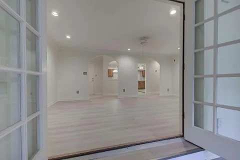 a view of a hallway with wooden floor