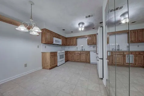 a view of a kitchen with a sink and microwave