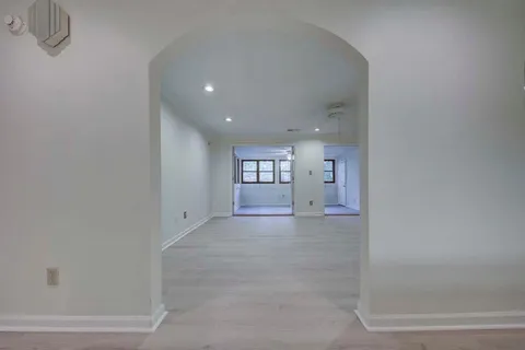 a view of a big room with wooden cabinet and windows