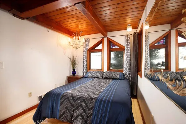 a bedroom with a bed and a large window with outer view