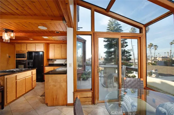 a kitchen with a glass top table and chairs
