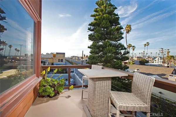 a view of a patio with couches and table and chairs and potted plants