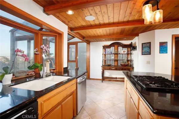 a kitchen with sink stove and cabinets